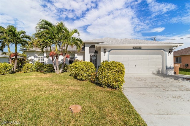 view of front of property with a front yard and a garage