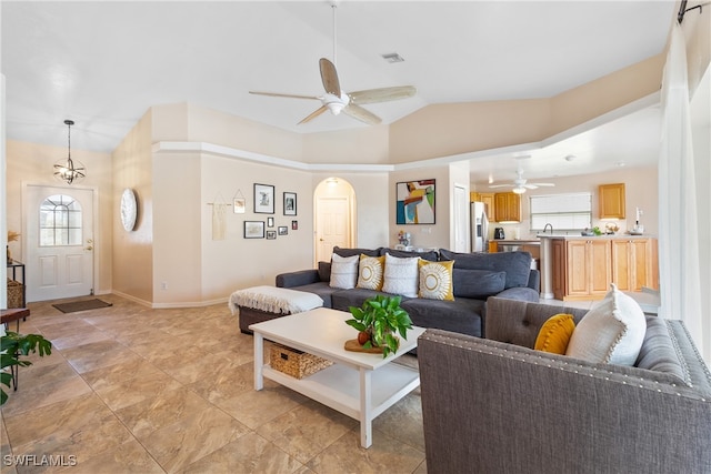 living room with ceiling fan, plenty of natural light, and lofted ceiling