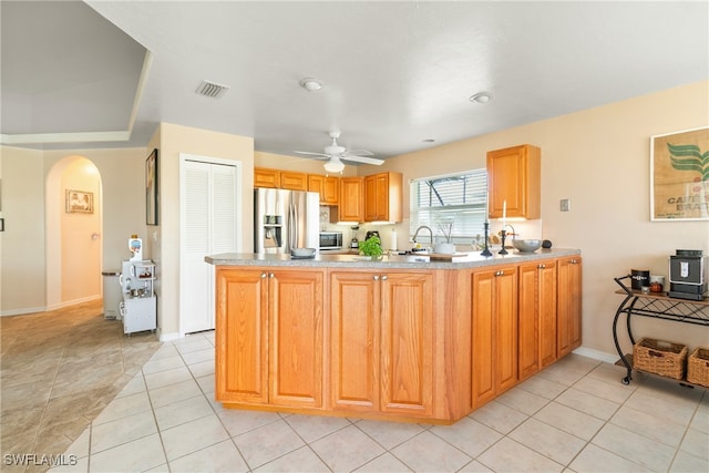 kitchen featuring stainless steel fridge with ice dispenser, sink, ceiling fan, and light tile patterned flooring