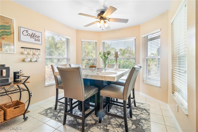 dining space with ceiling fan, a healthy amount of sunlight, and light tile patterned flooring