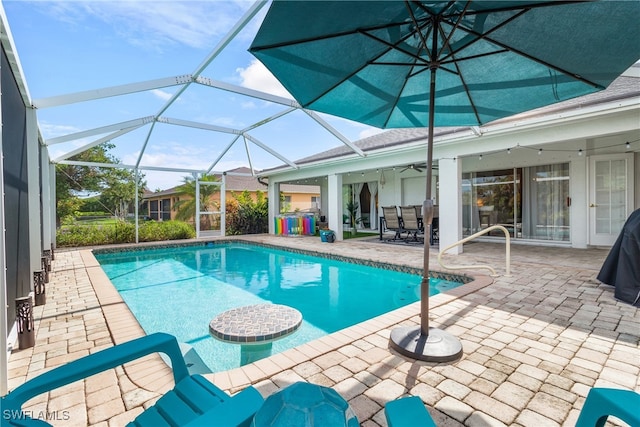 view of swimming pool featuring a patio area and glass enclosure