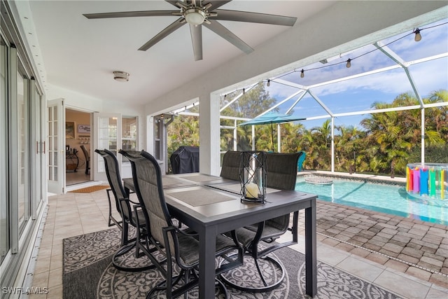 view of patio featuring ceiling fan and a lanai