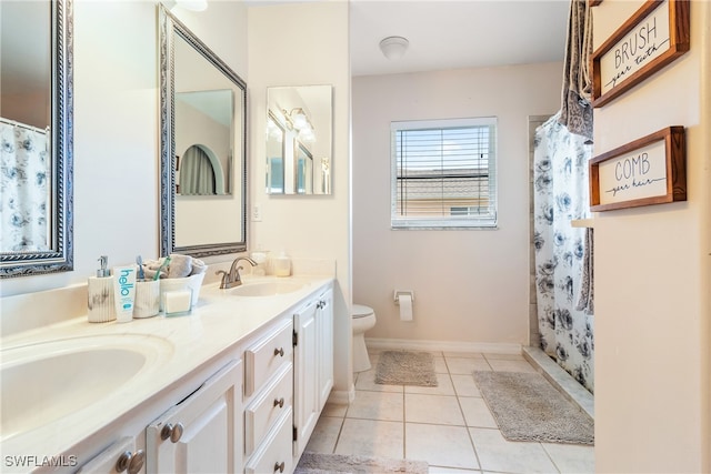 bathroom featuring toilet, a shower with curtain, vanity, and tile patterned floors