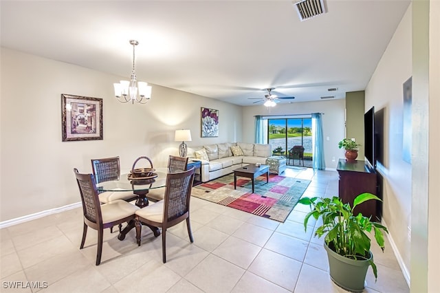 dining room featuring ceiling fan with notable chandelier and light tile patterned floors