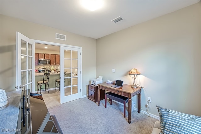 carpeted office featuring french doors