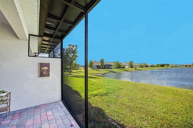 unfurnished sunroom with a water view