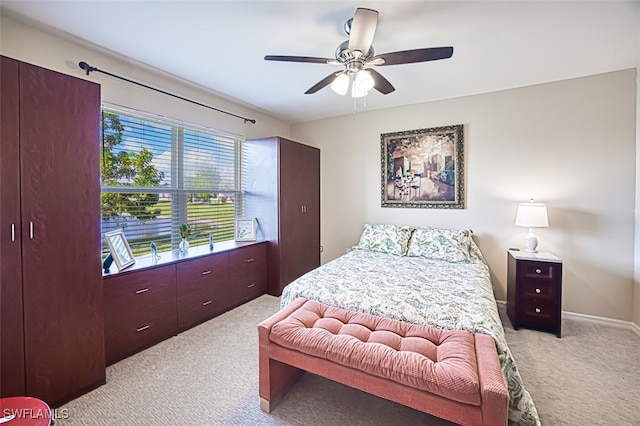 bedroom with ceiling fan and light carpet