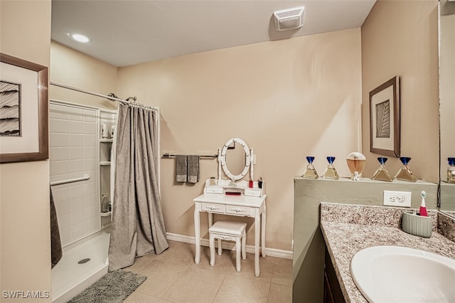 bathroom featuring walk in shower, tile patterned flooring, and vanity