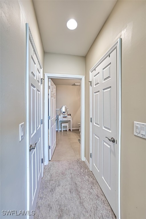 hallway featuring light carpet