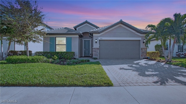 view of front of house with a lawn and a garage