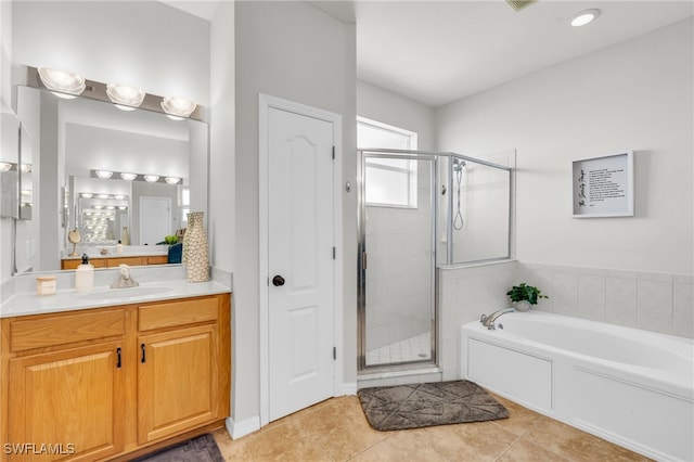 bathroom with vanity, tile patterned floors, and separate shower and tub