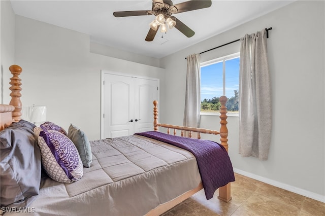 bedroom featuring a closet, ceiling fan, and light tile patterned flooring