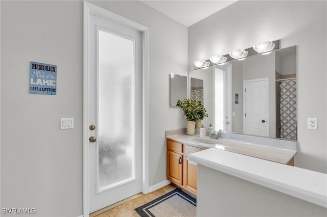 bathroom featuring a shower with curtain, tile patterned floors, and vanity