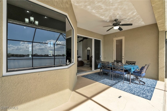 view of patio / terrace featuring ceiling fan and glass enclosure