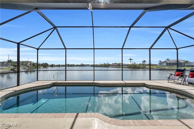 view of pool with a patio, a water view, and glass enclosure