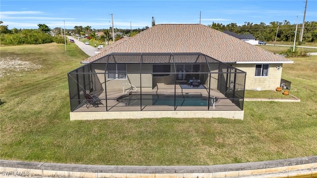 rear view of house with a patio, a lanai, and a yard