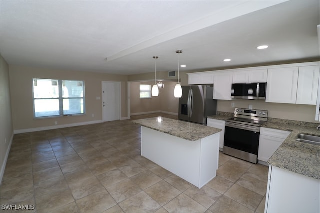 kitchen featuring white cabinetry, plenty of natural light, decorative light fixtures, and appliances with stainless steel finishes