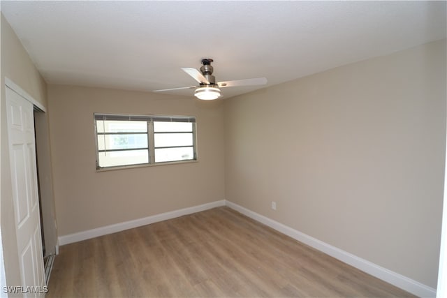 unfurnished bedroom featuring light hardwood / wood-style flooring, ceiling fan, and a closet