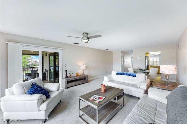 carpeted living room featuring ceiling fan