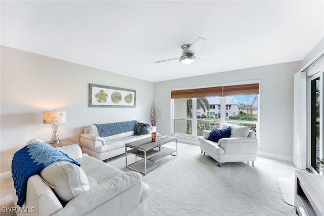 carpeted living room featuring ceiling fan