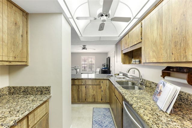 kitchen with stainless steel dishwasher, light stone countertops, ceiling fan, and sink