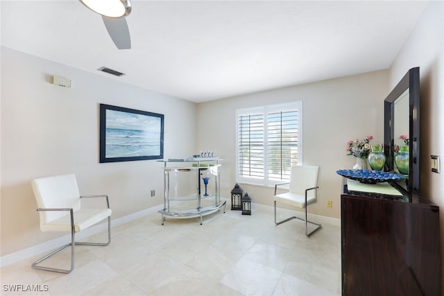 living area featuring ceiling fan