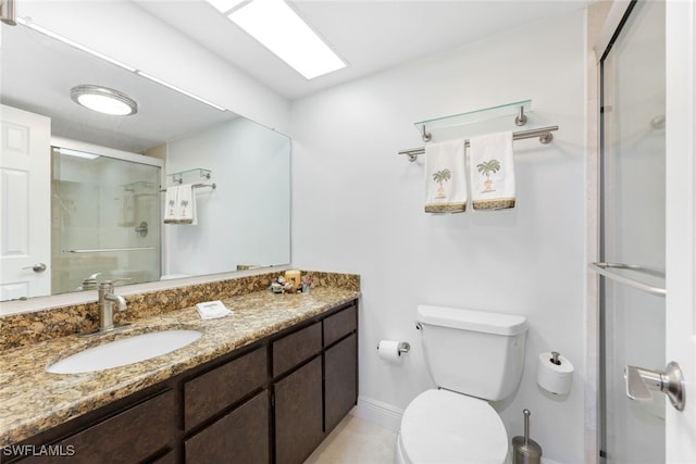 bathroom featuring walk in shower, vanity, and toilet