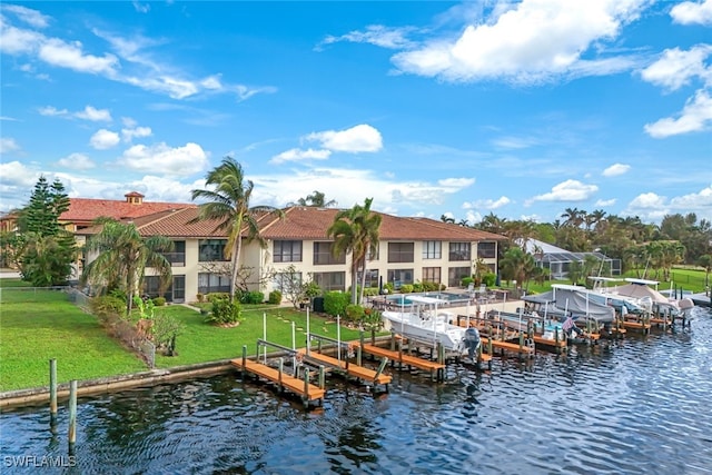 view of dock with a water view and a yard