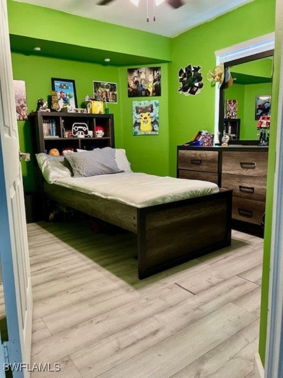 bedroom with light wood-type flooring and ceiling fan