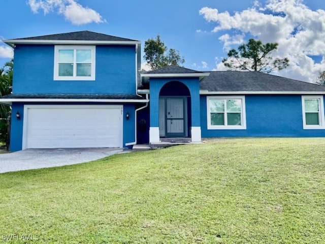 view of front of house featuring a front lawn and a garage