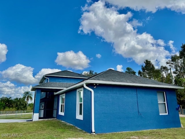 view of property exterior featuring a lawn