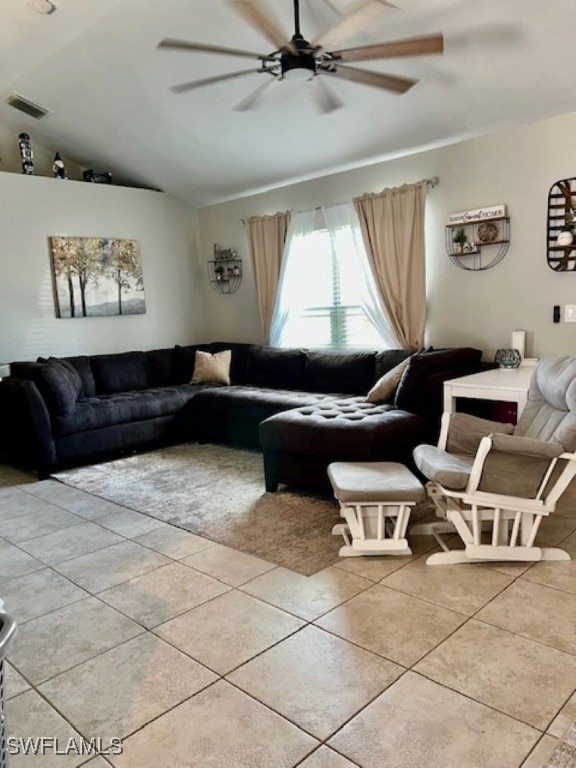 living room with ceiling fan, light tile patterned floors, and lofted ceiling