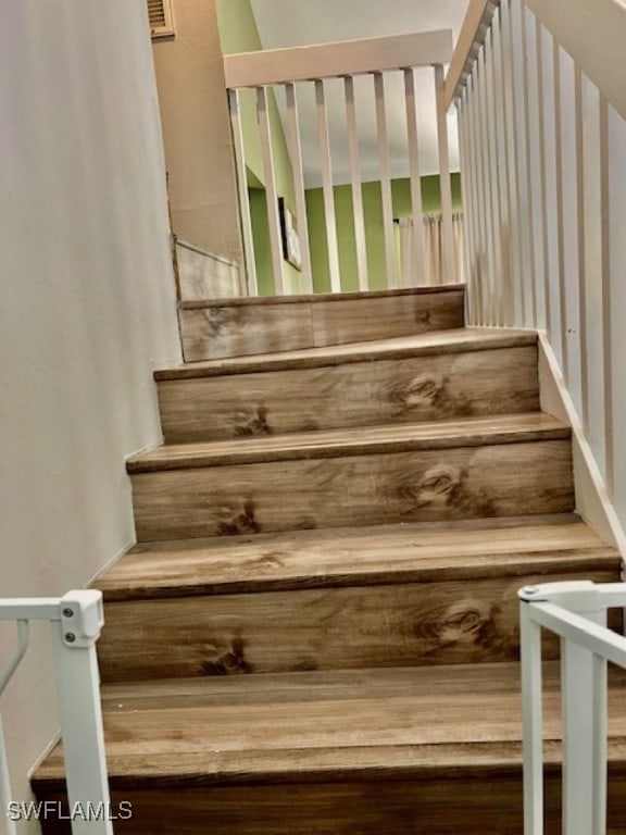 staircase with wood-type flooring