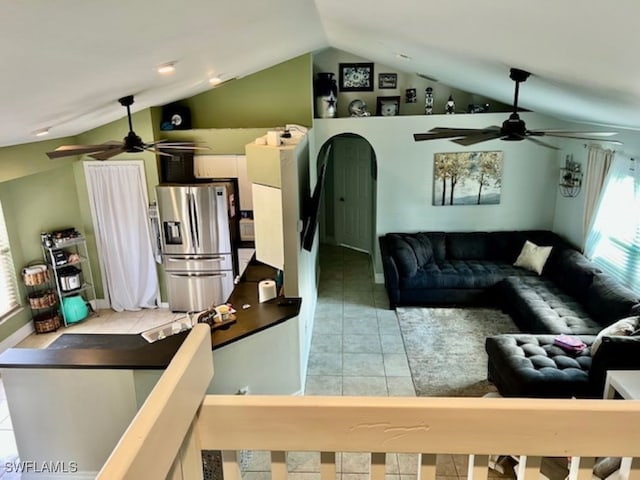 tiled living room featuring lofted ceiling and ceiling fan