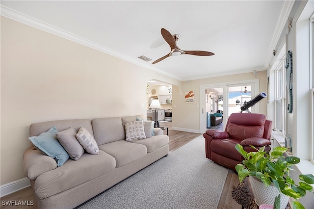 living room featuring crown molding, ceiling fan, and hardwood / wood-style floors