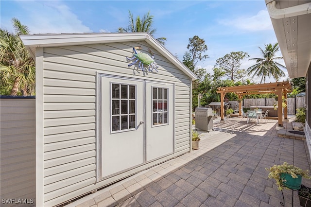 view of outbuilding featuring a pergola