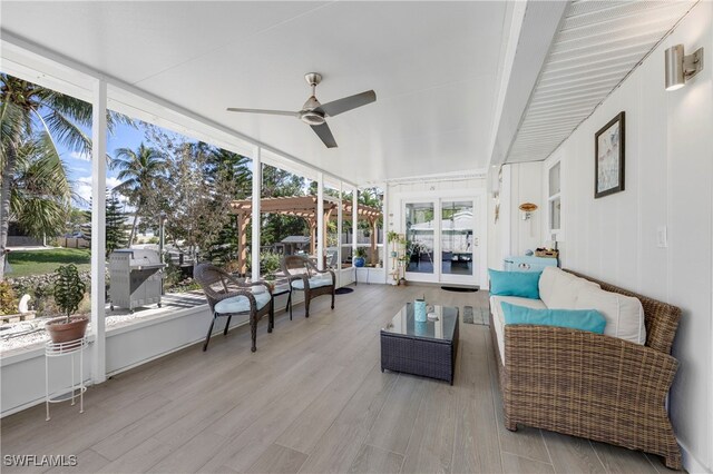 sunroom featuring ceiling fan