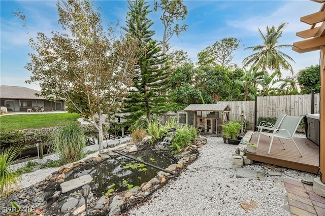 view of yard with a wooden deck and an outdoor structure