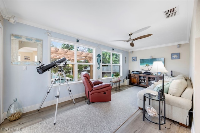 living room with crown molding, ceiling fan, and hardwood / wood-style flooring