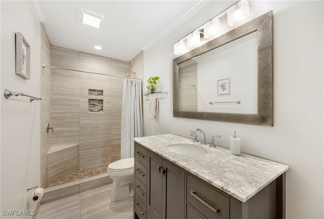 bathroom featuring a shower with curtain, ornamental molding, vanity, and toilet