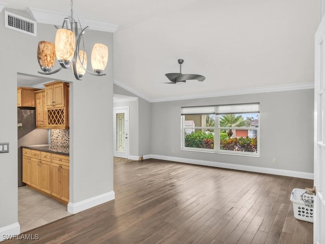 unfurnished living room featuring light hardwood / wood-style floors, ceiling fan with notable chandelier, and crown molding