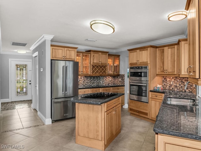 kitchen featuring stainless steel appliances, sink, a kitchen island, and ornamental molding