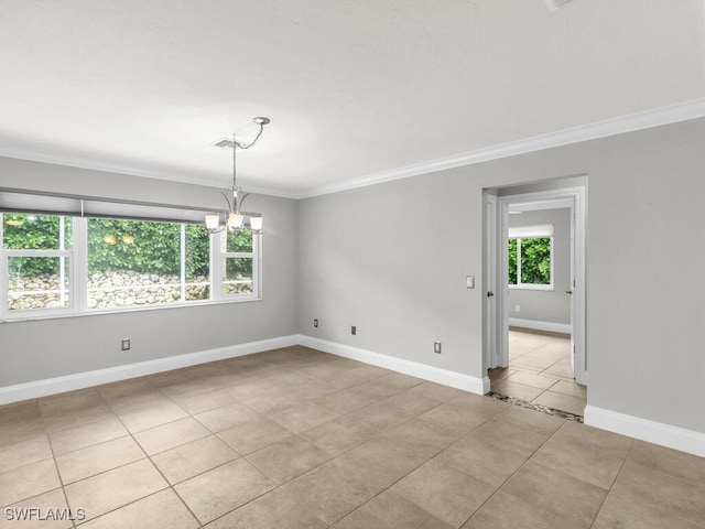 spare room featuring a notable chandelier, a healthy amount of sunlight, crown molding, and light tile patterned floors