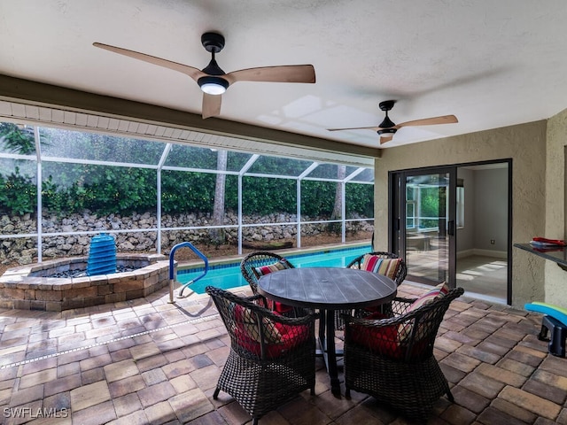 view of patio / terrace featuring glass enclosure and ceiling fan