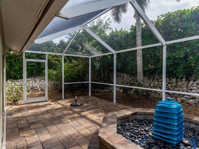 view of patio with glass enclosure