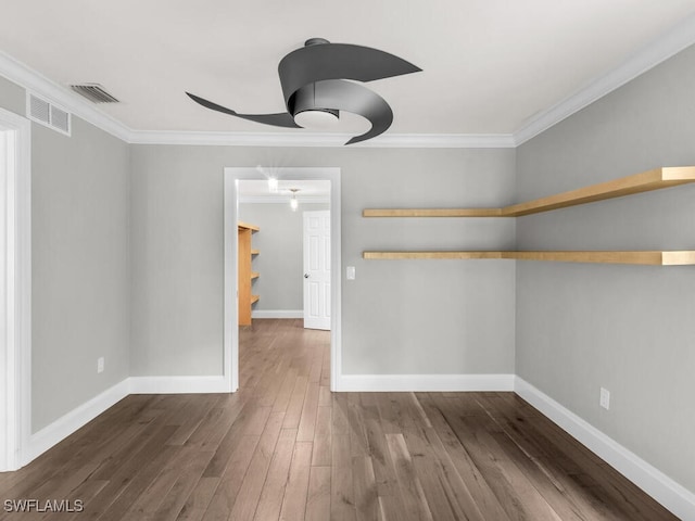 interior space featuring ceiling fan, crown molding, and dark hardwood / wood-style flooring