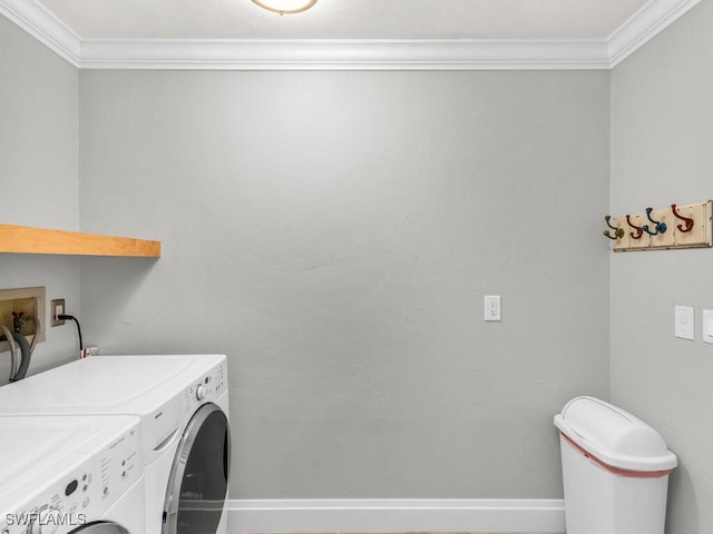 laundry area with separate washer and dryer and crown molding