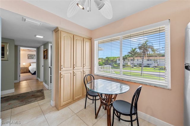 tiled dining space featuring ceiling fan