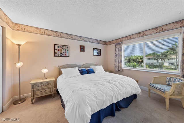 carpeted bedroom featuring a textured ceiling