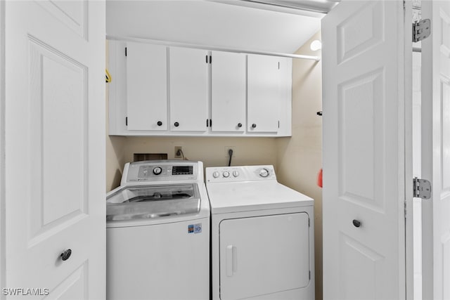 washroom with cabinets and separate washer and dryer